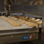 Artisan bread baking in an industrial oven at a bakery in Berlin, Germany. Fresh and delicious. - Photo by Travel with Lenses on Pexels