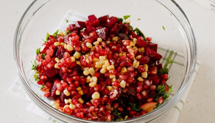 A fresh and colorful pomegranate beetroot salad with corn in a glass bowl indoors. - Photo by The Design Lady on Pexels